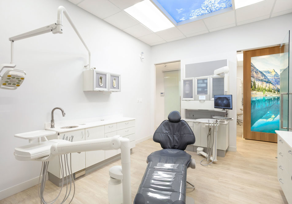 A treatment room with a Skyfactory sky ceiling and BC mountain mural